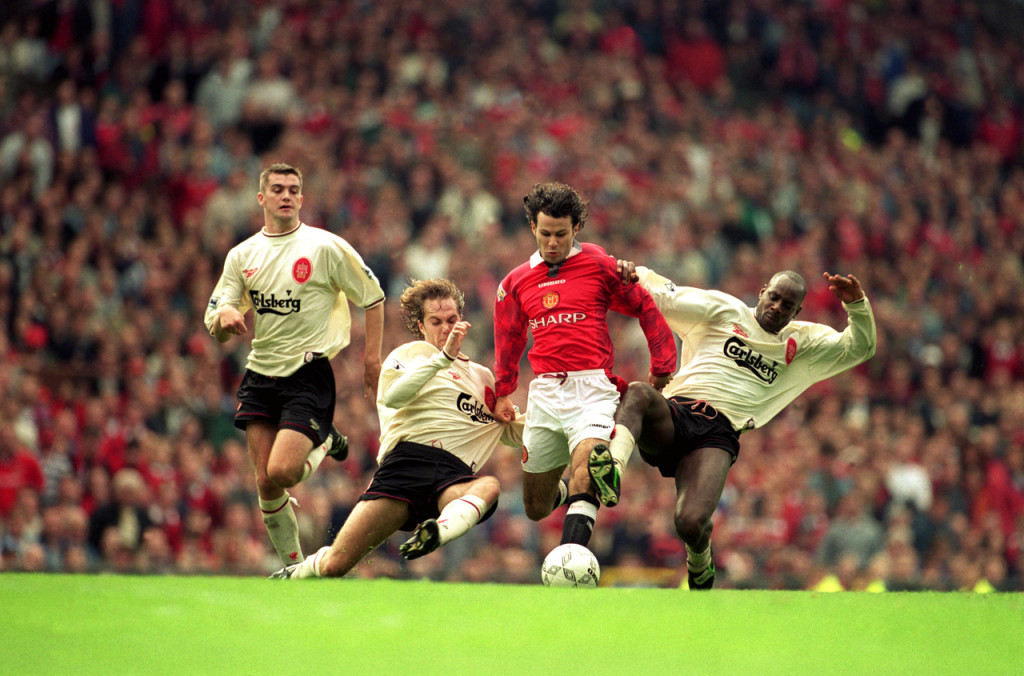 Ryan Giggs of Manchester United and Jason McAteer (left) and Michael Thomas (right) of Liverpool